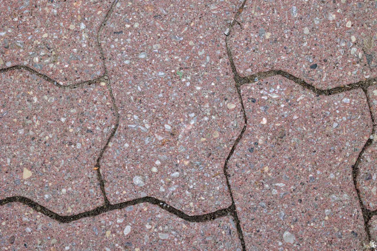Detailed close-up of red brick pavement showcasing unique patterns.